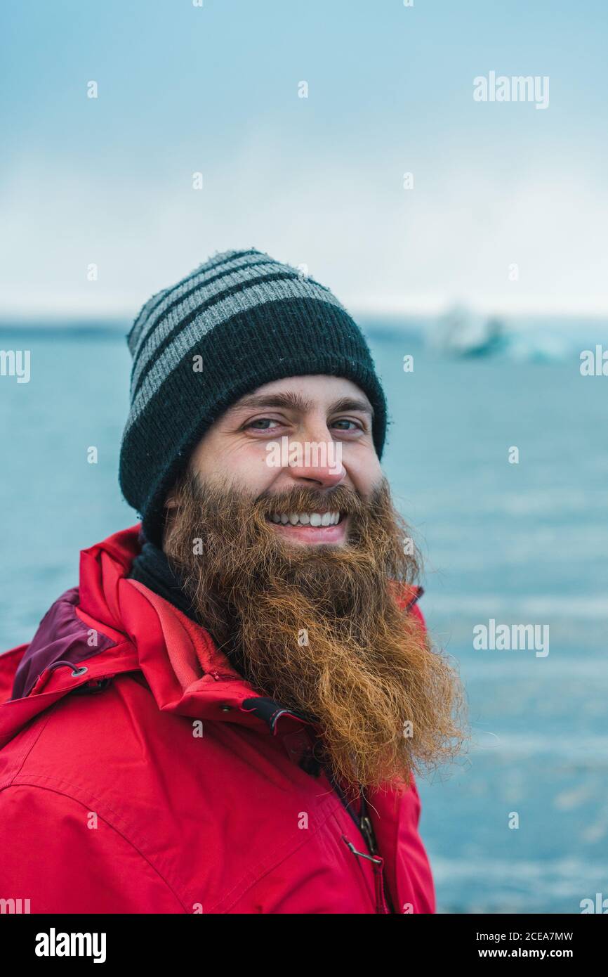 Attractive bearded man in warm clothes by water Stock Photo