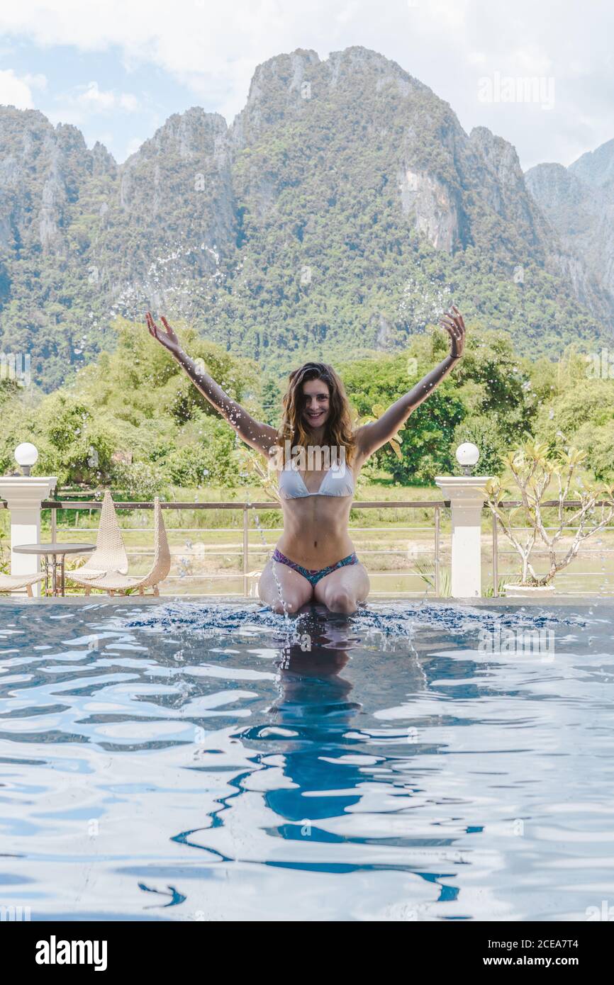 Attractive Woman in bikini at poolside Stock Photo