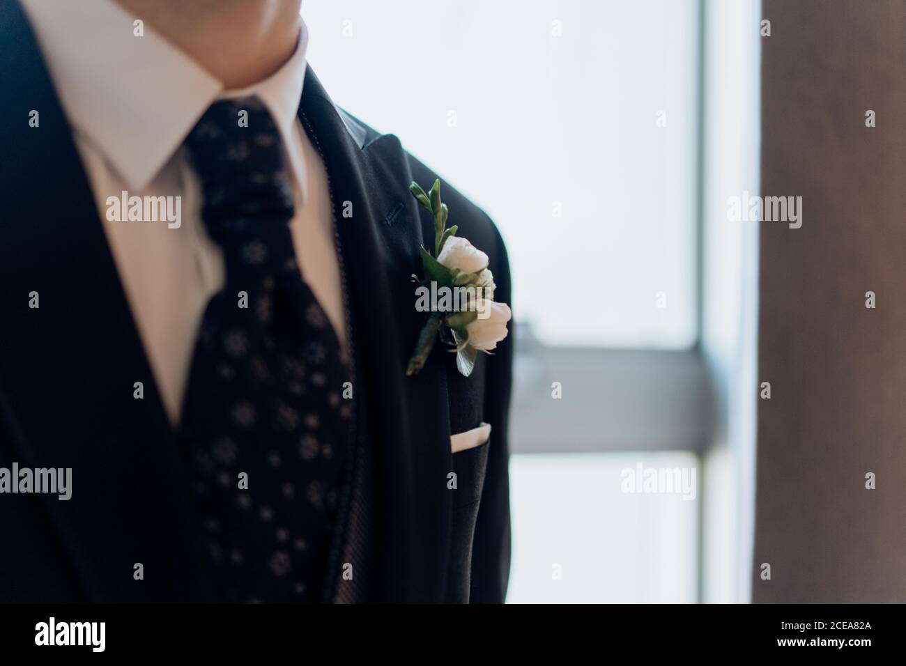 Crop groom in elegant tie and suit Stock Photo