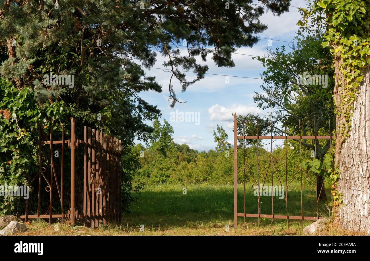 Open iron gate in an agricultural field Stock Photo