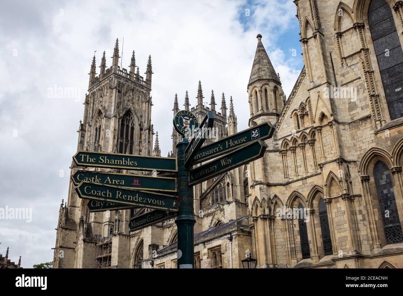 Looking up at York Minster with ornate point of interest sign in foreground on Minster Yard, York, Yorkshire UK Stock Photo