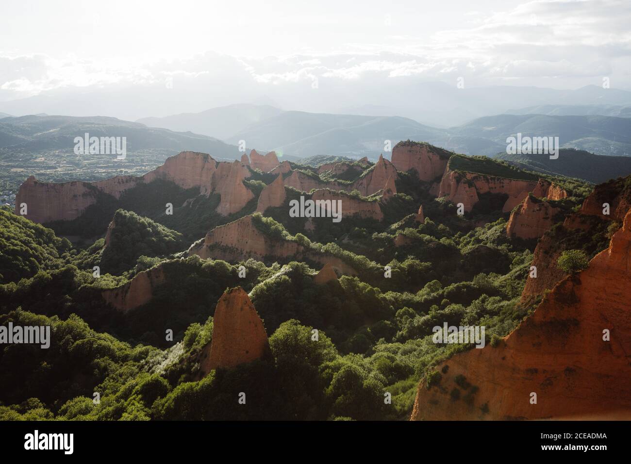 Painterly valley with green forest between red scales in Cantabria, Spain Stock Photo