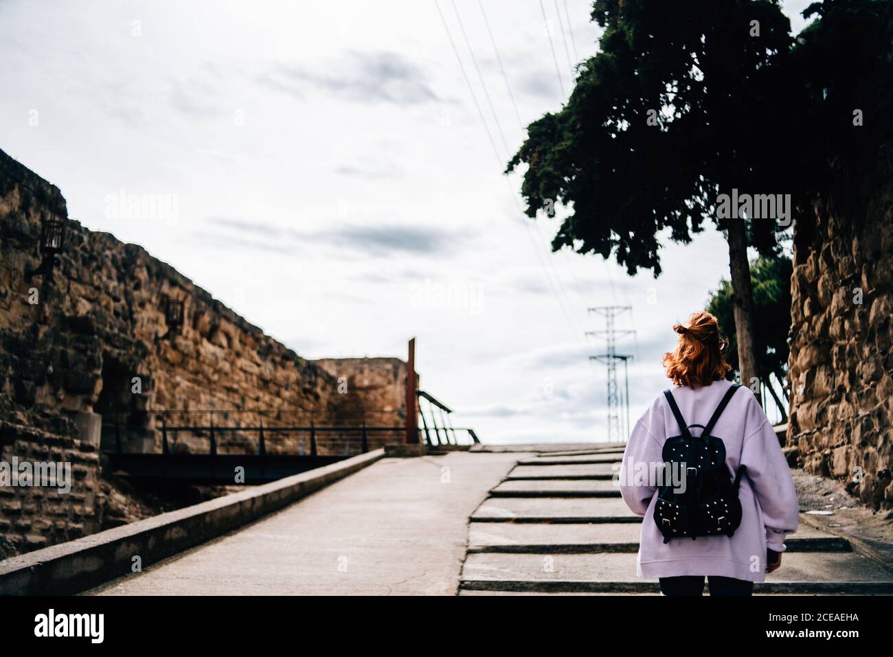 Young Woman with backpack going in forest Stock Photo