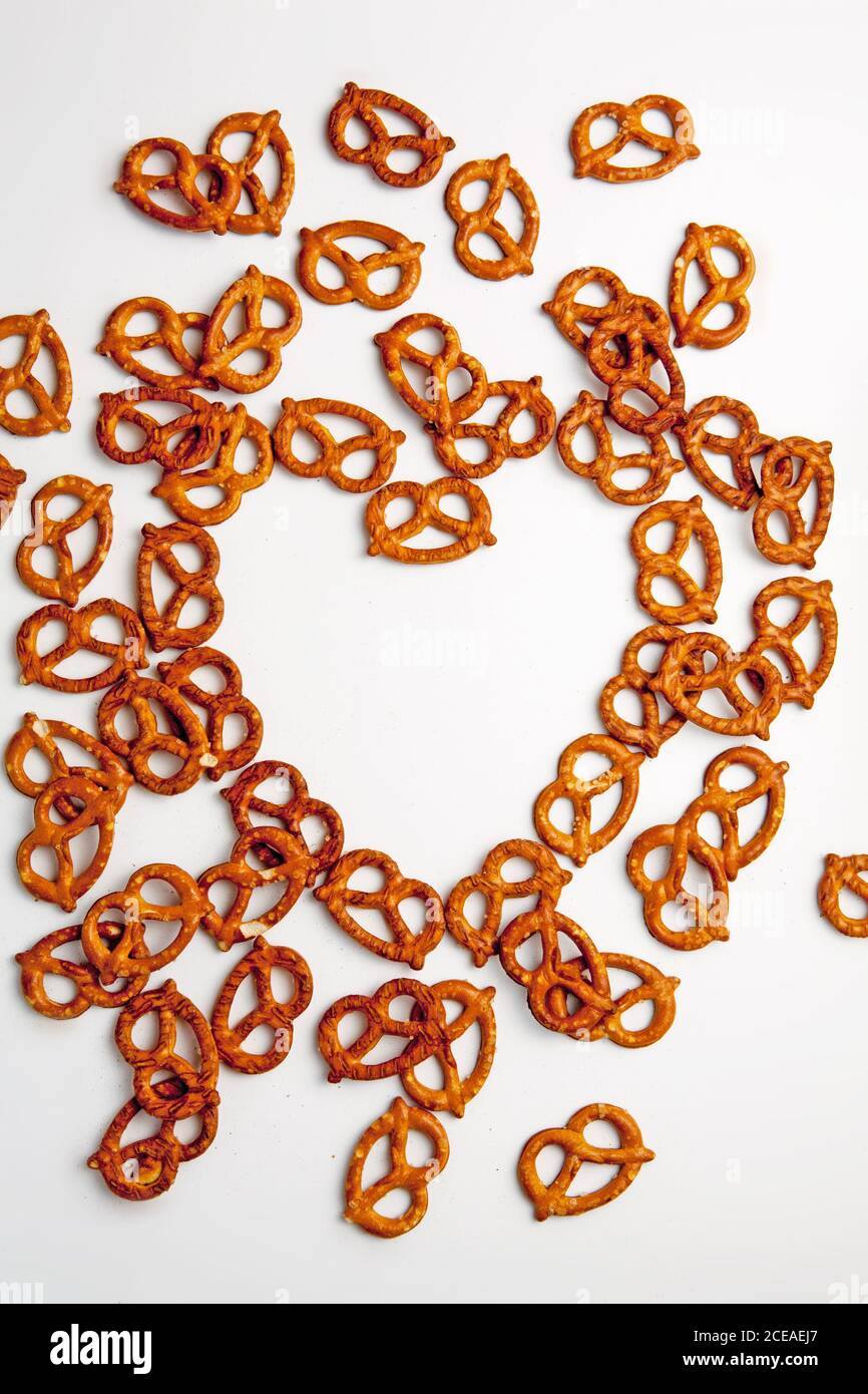 Pretzels in a heart shape on a white background Stock Photo Alamy