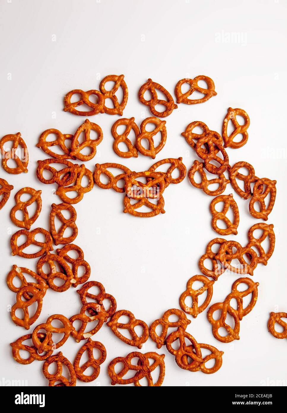 Pretzels in a heart shape on a white background Stock Photo