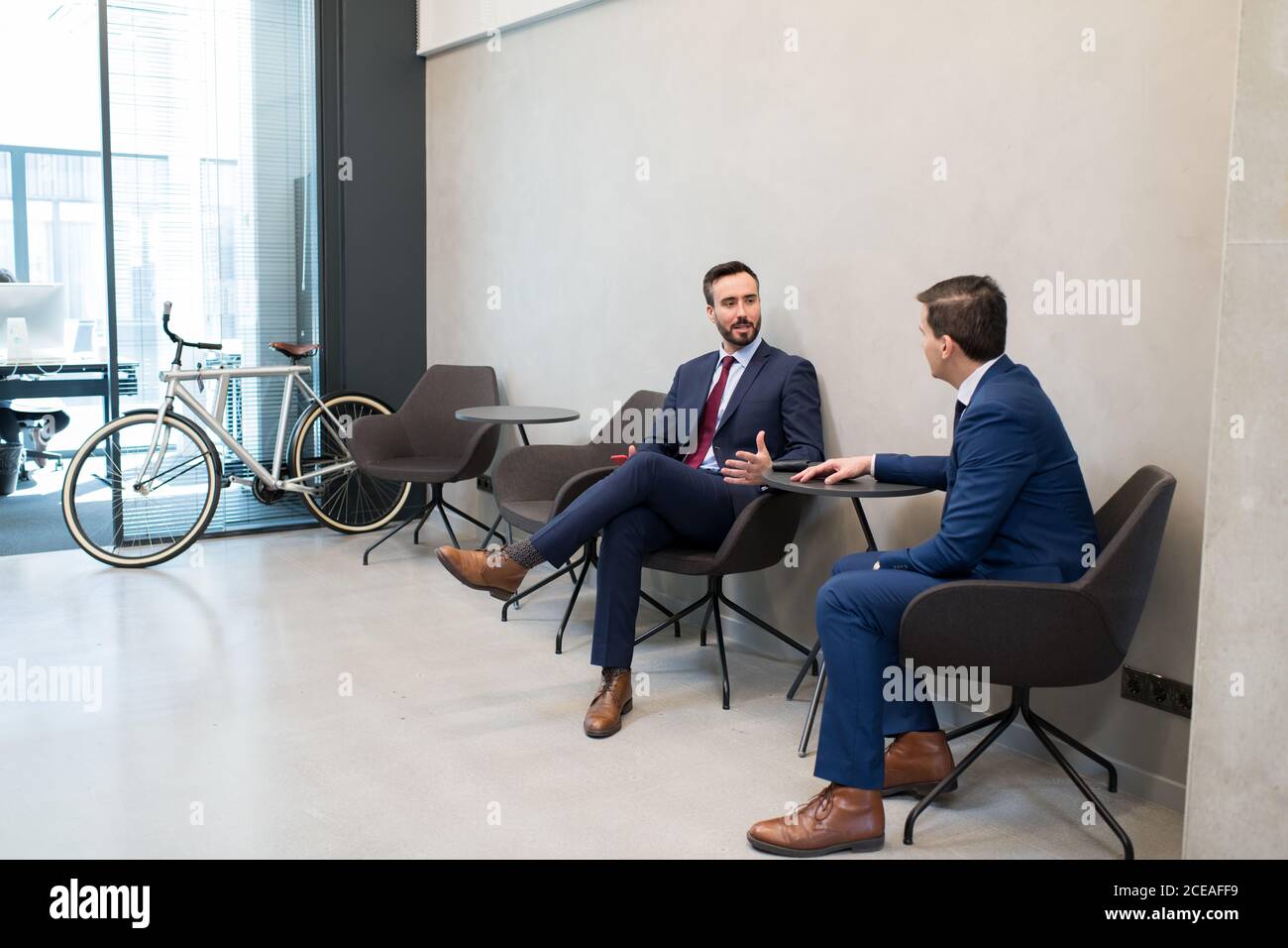 Trendy businessmen sharing knowledge Stock Photo