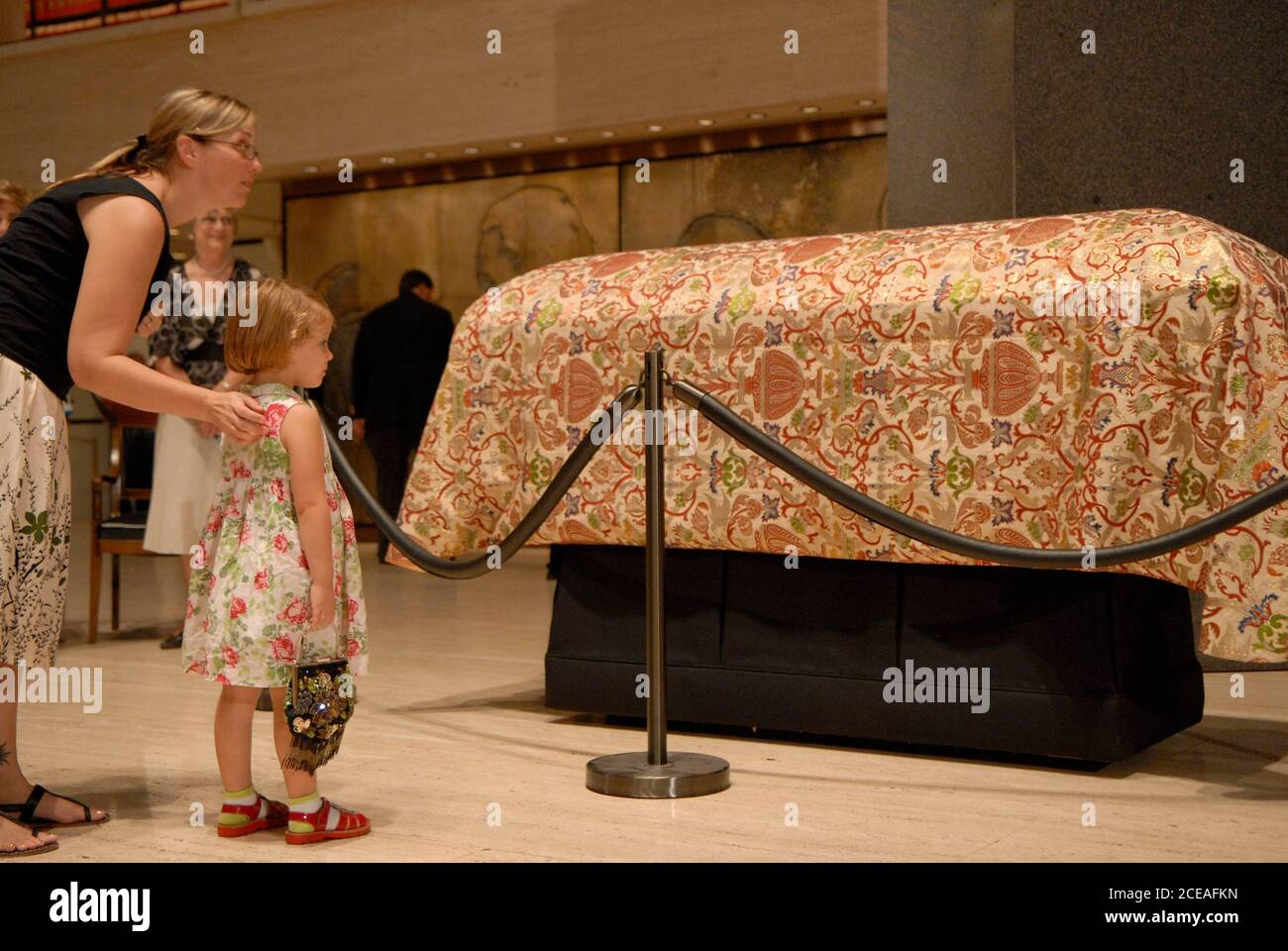 Austin, TX July 13, 2007: A young girl and her mother visit the casket of Lady Bird Johnson, former First Lady and widow of former president Lyndon Baines Johnson, during a memorial viewing at the LBJ Library in Austin. ©Bob Daemmrich Stock Photo