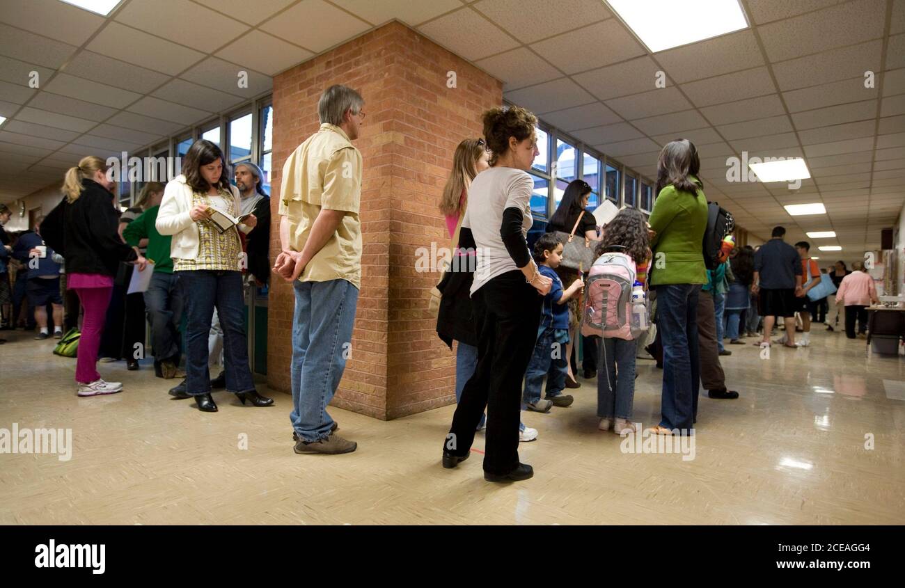 Austin, TX March 4, 2008: Voters in Precinct 342 at Barton Hills Elementary School in south Austin wait in line during the Texas primary election Tuesday night. About 100 voters were in line when the polls officially closed at 7:00PM but were still allowed to cast ballots. ©Bob Daemmrich Stock Photo