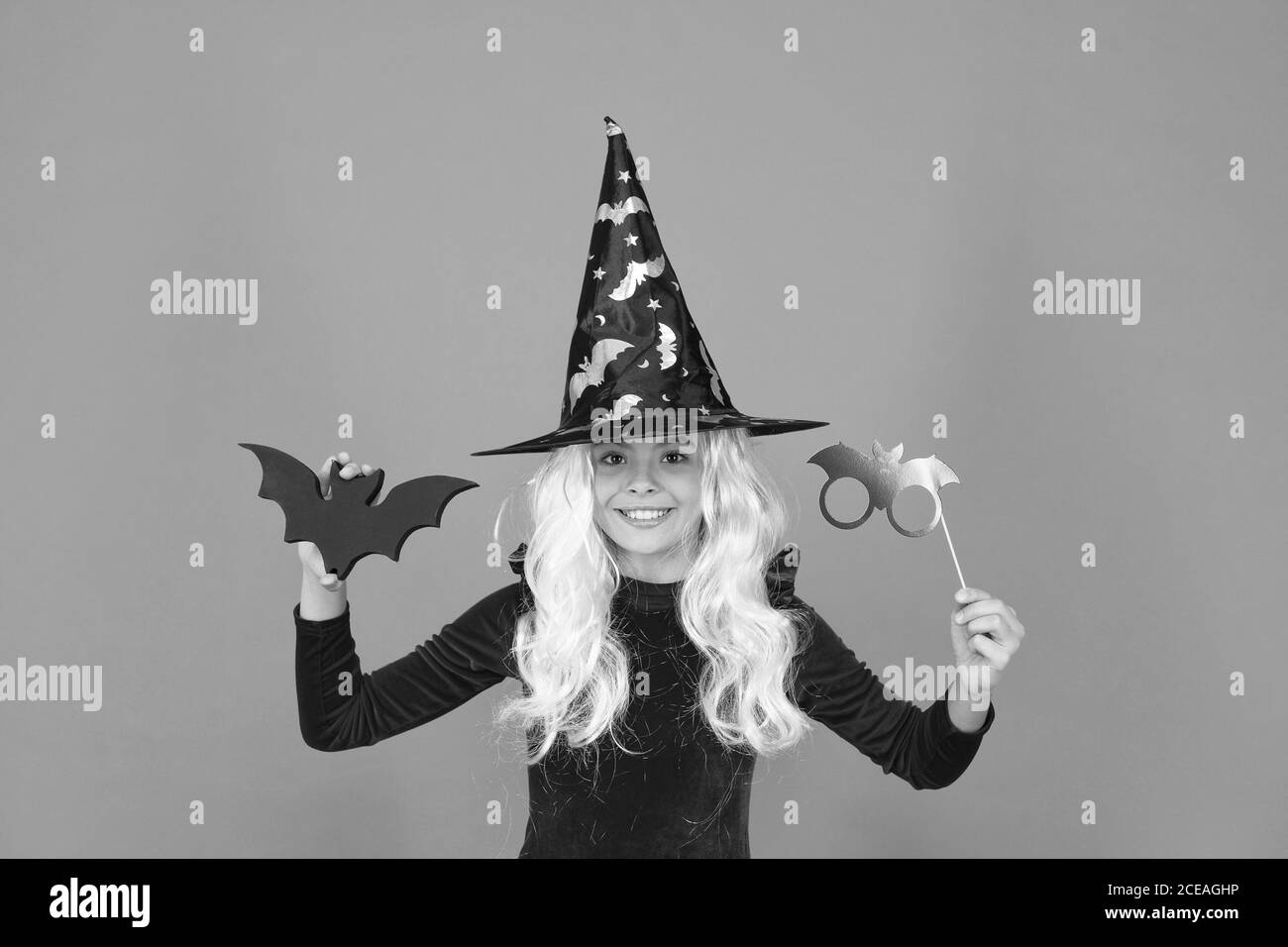 The scariest party tonight. Party girl with Halloween props orange background. Small child wear