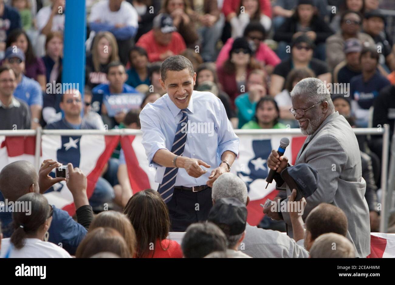 San Antonio, TX  February 19, 2008:  Democratic presidential hopeful Barack Obama speaks to a predominately Mexican-American crowd outdoors at Plaza Guadalupe on San Antonio's west side as a crowd of about 2,500 heard him speak about his aspirations if he becomes President. Here is shown answering a question from a man in the audience (right).  ©Bob Daemmrich Stock Photo