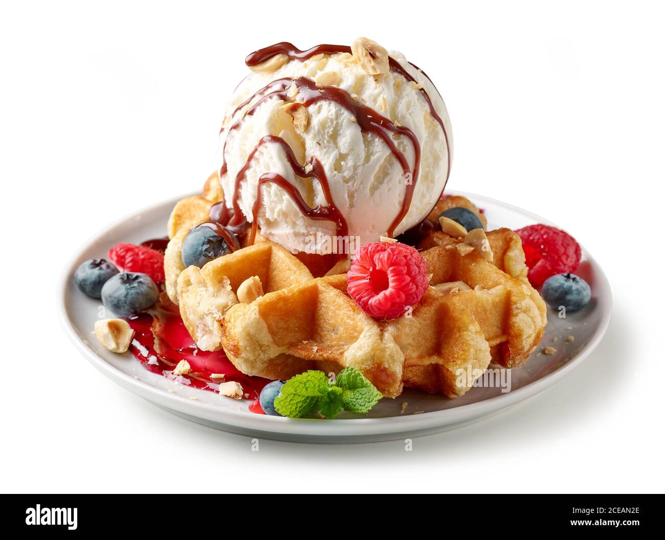 portion of belgian waffle with ice cream and fresh berries isolated on ...