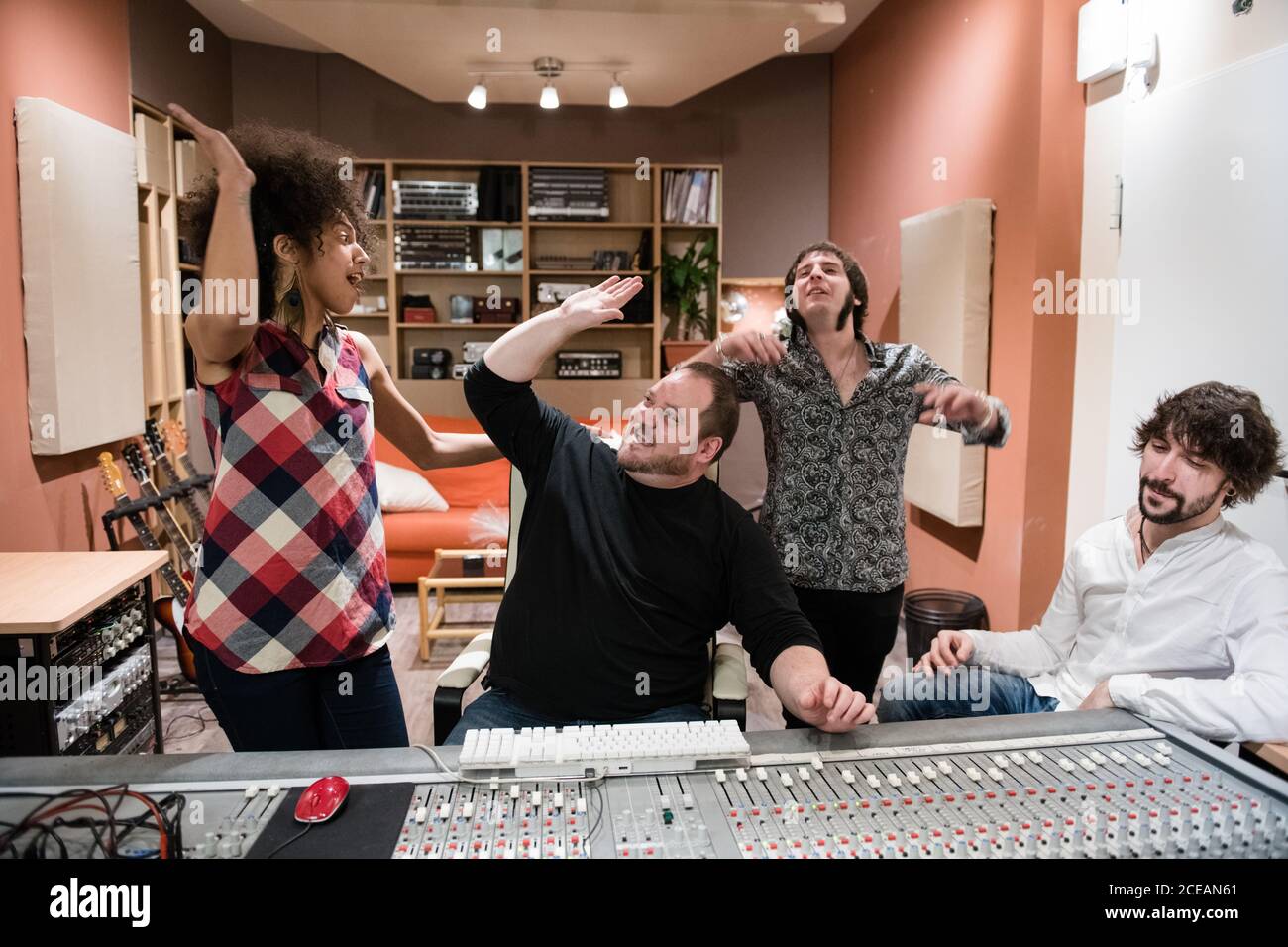 Group of people rejoicing over success and having fun?after recording music in studio Stock Photo