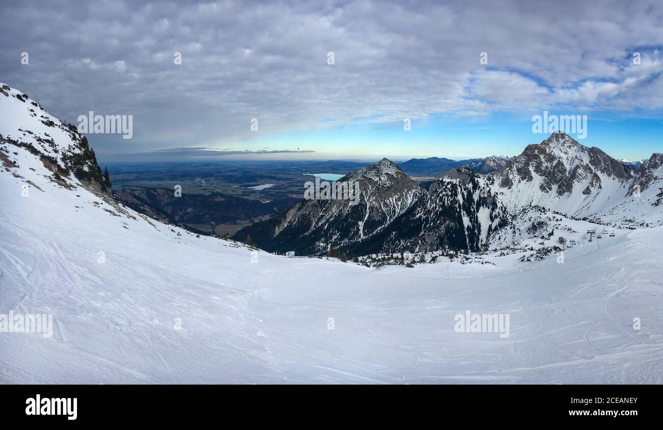 Scenic view from Austrian ski region Tannheimer Tal (Tannheim valley) in the region of Tyrol to the German region of east Allgäu with Hopfensee and Fo Stock Photo