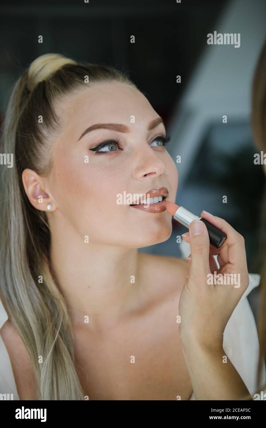 Woman applying make up on a bride Stock Photo