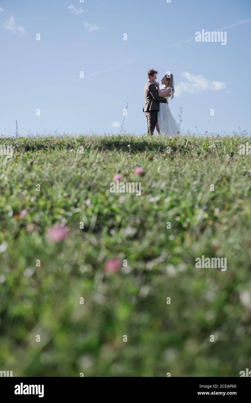 Bride and groom holding each other in the nature Stock Photo - Alamy