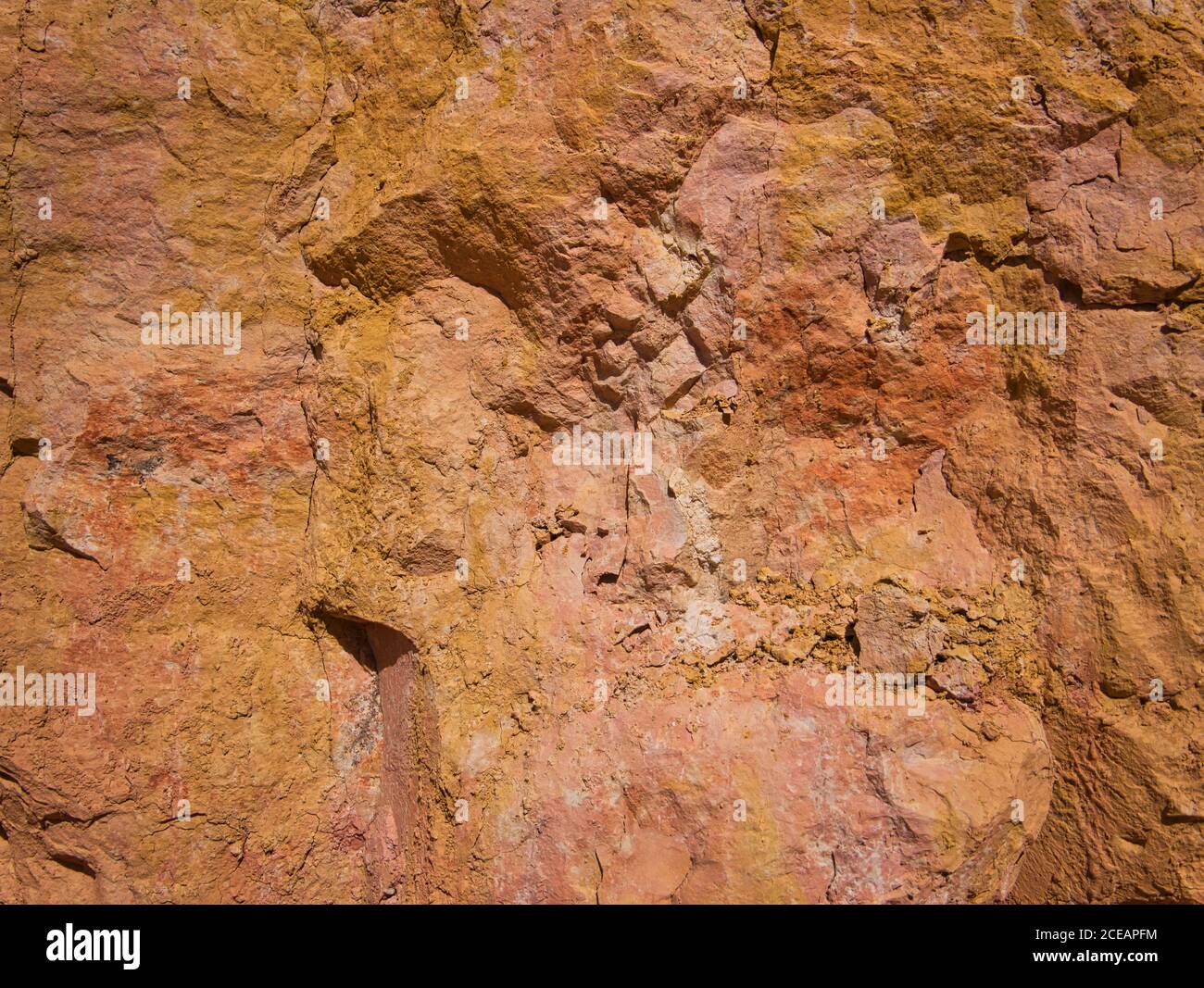 A golden boulder with small cracks and slight discoloration Stock Photo