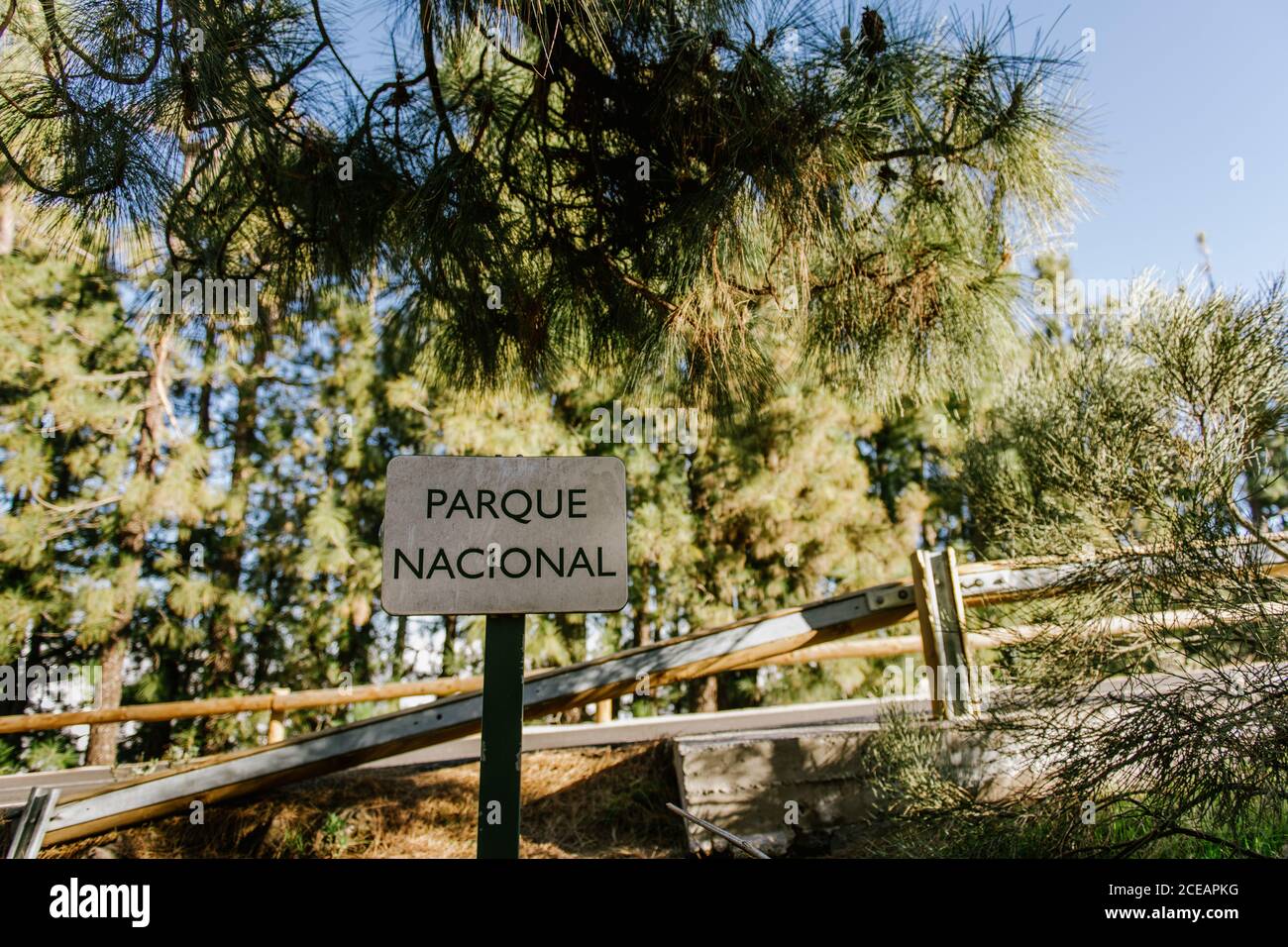 Parqueo Sign Parque Nacional sign placed at wooden walkway in green forest Stock ...
