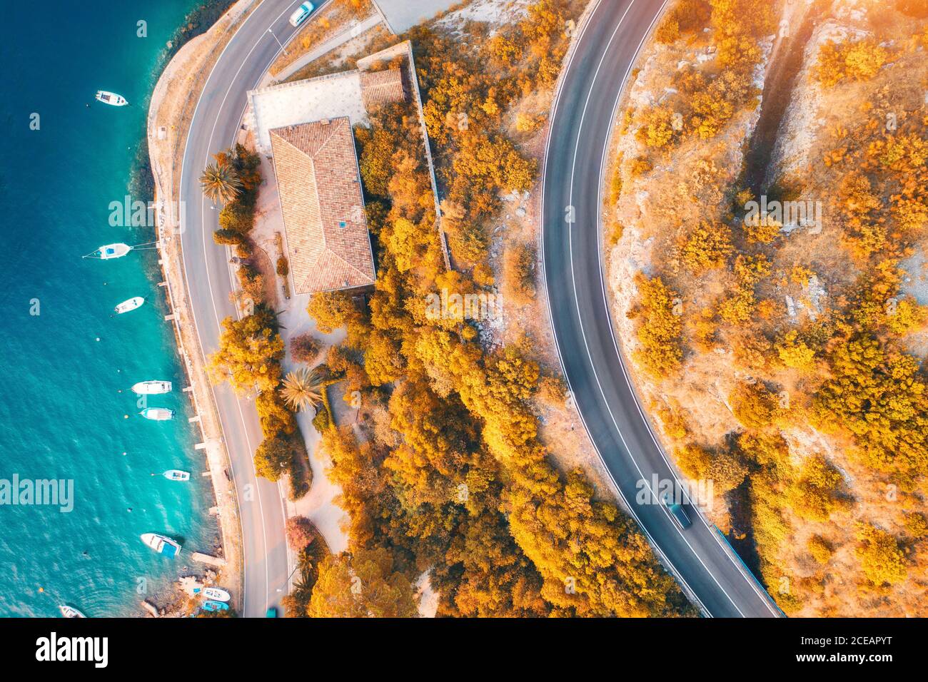 Aerial view of road and boats in the sea at sunset in autumn Stock Photo