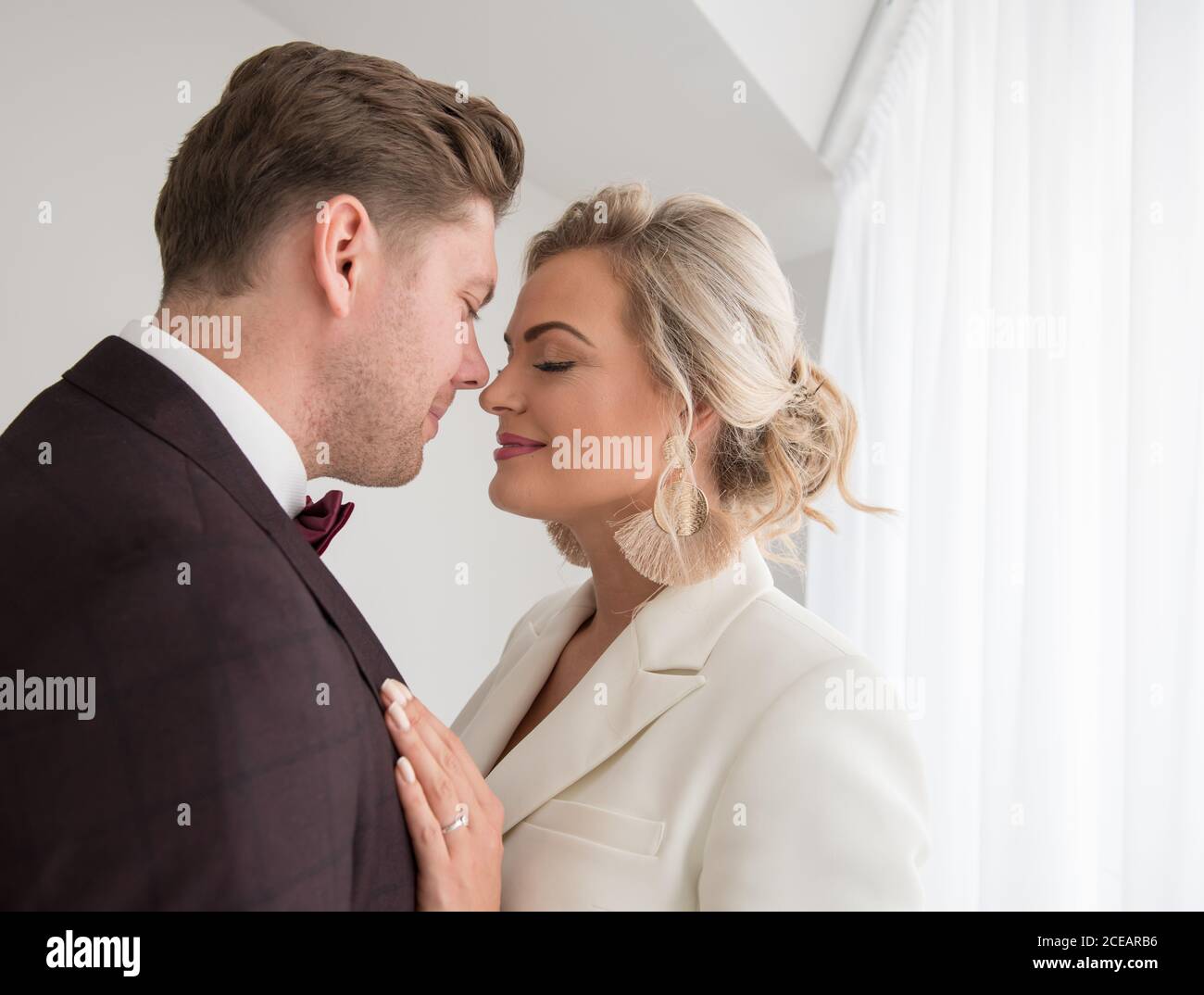 Handsome man hugging beautiful woman hi-res stock photography and ...