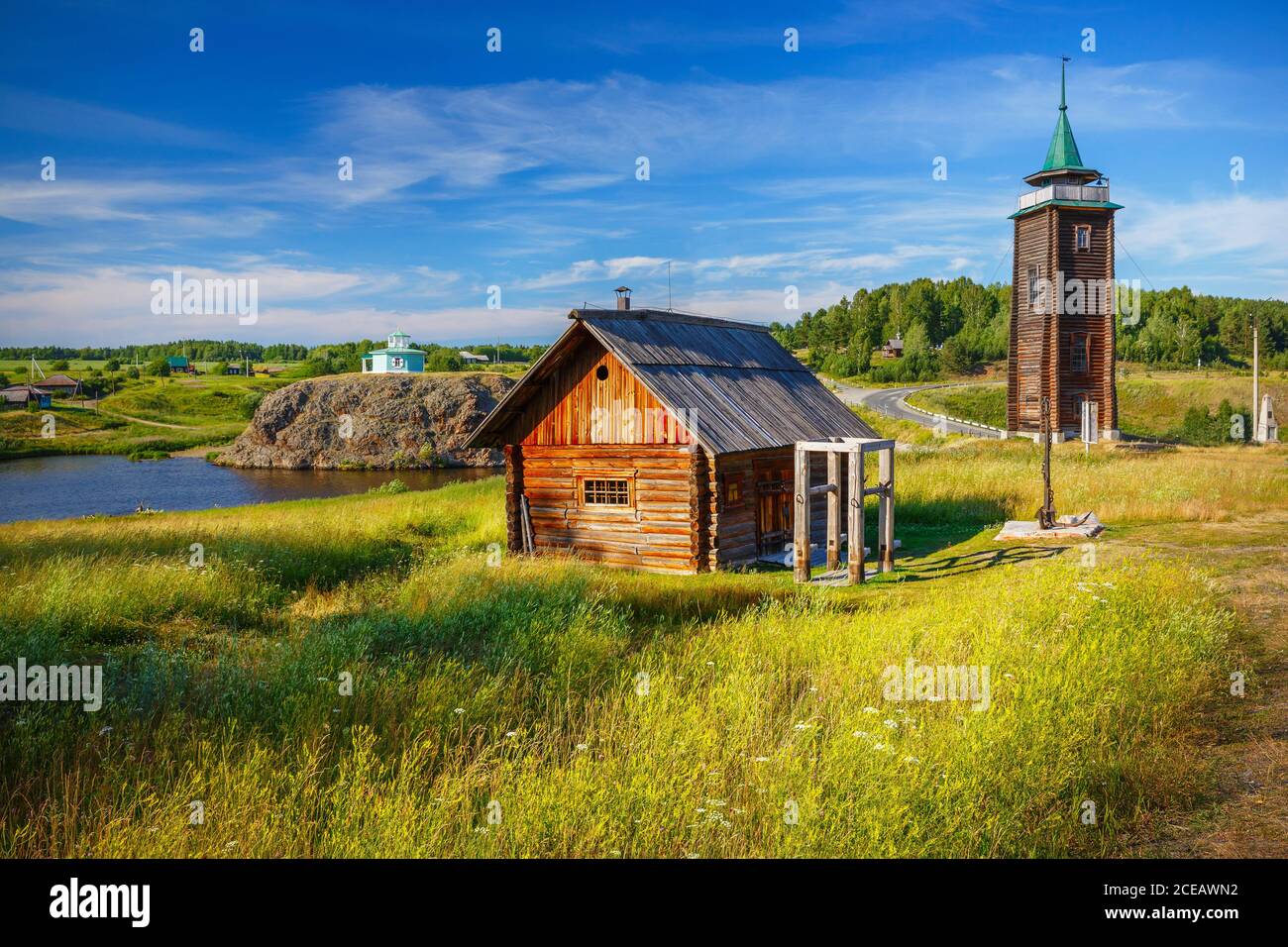 russian countryside with old log house and fire tower Stock Photo