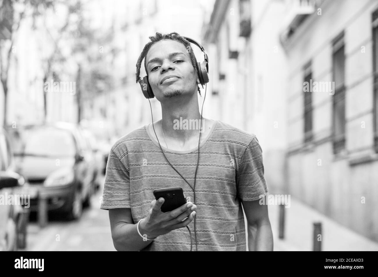 Black man on his phone smiling Black and White Stock Photos & Images