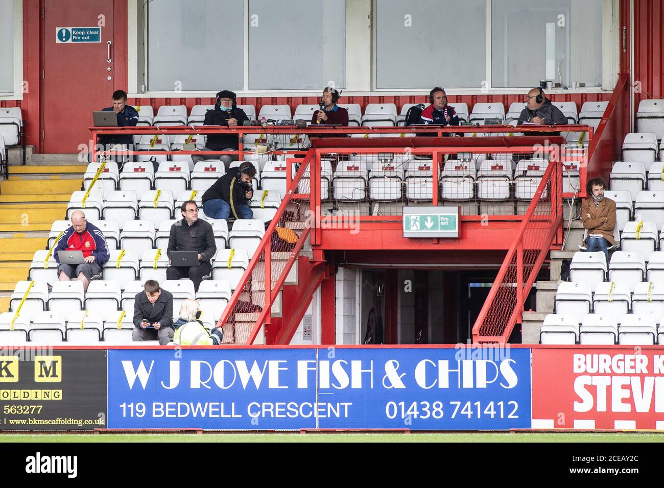 Press and journalists sit in a socially distanced manner during professional football / soccer match during Covid 19 Coronavirus pandemic in UK Stock Photo