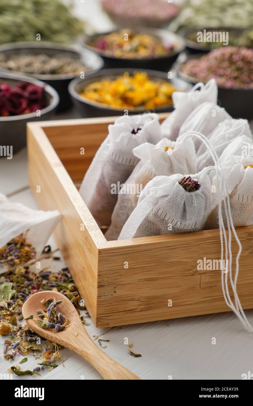 Wooden box of filter tea bags filled with dry medicinal herbs and ...