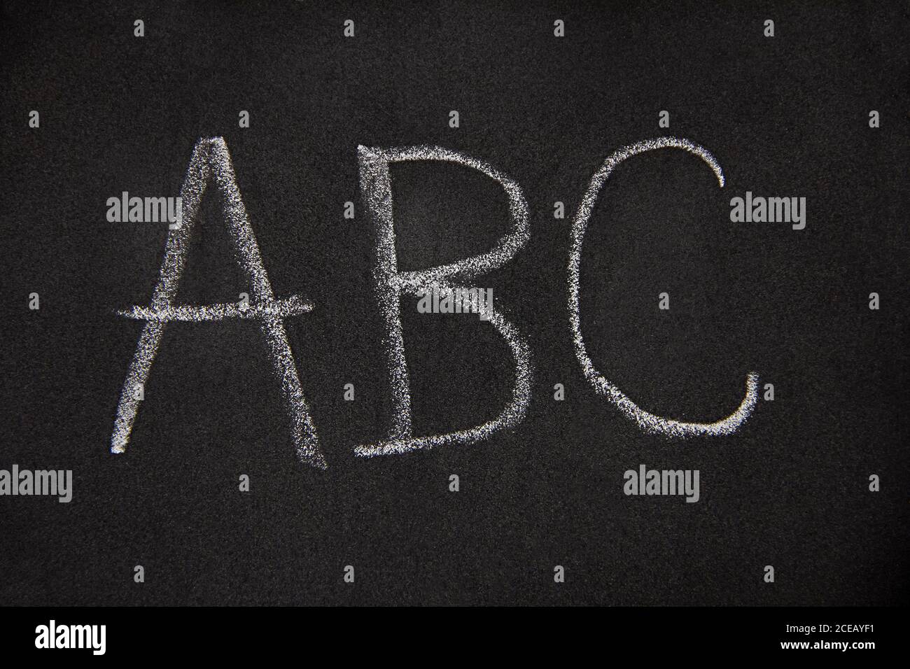 the letters A, B, C isolated on black, closeup of first english alphabet letters written on a blackboard with a piece of chalk Stock Photo