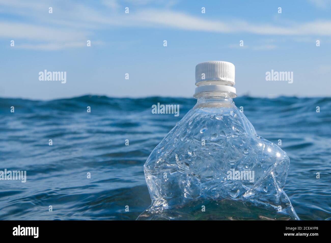 A plastic bottle floats on the surface of the water in the open sea