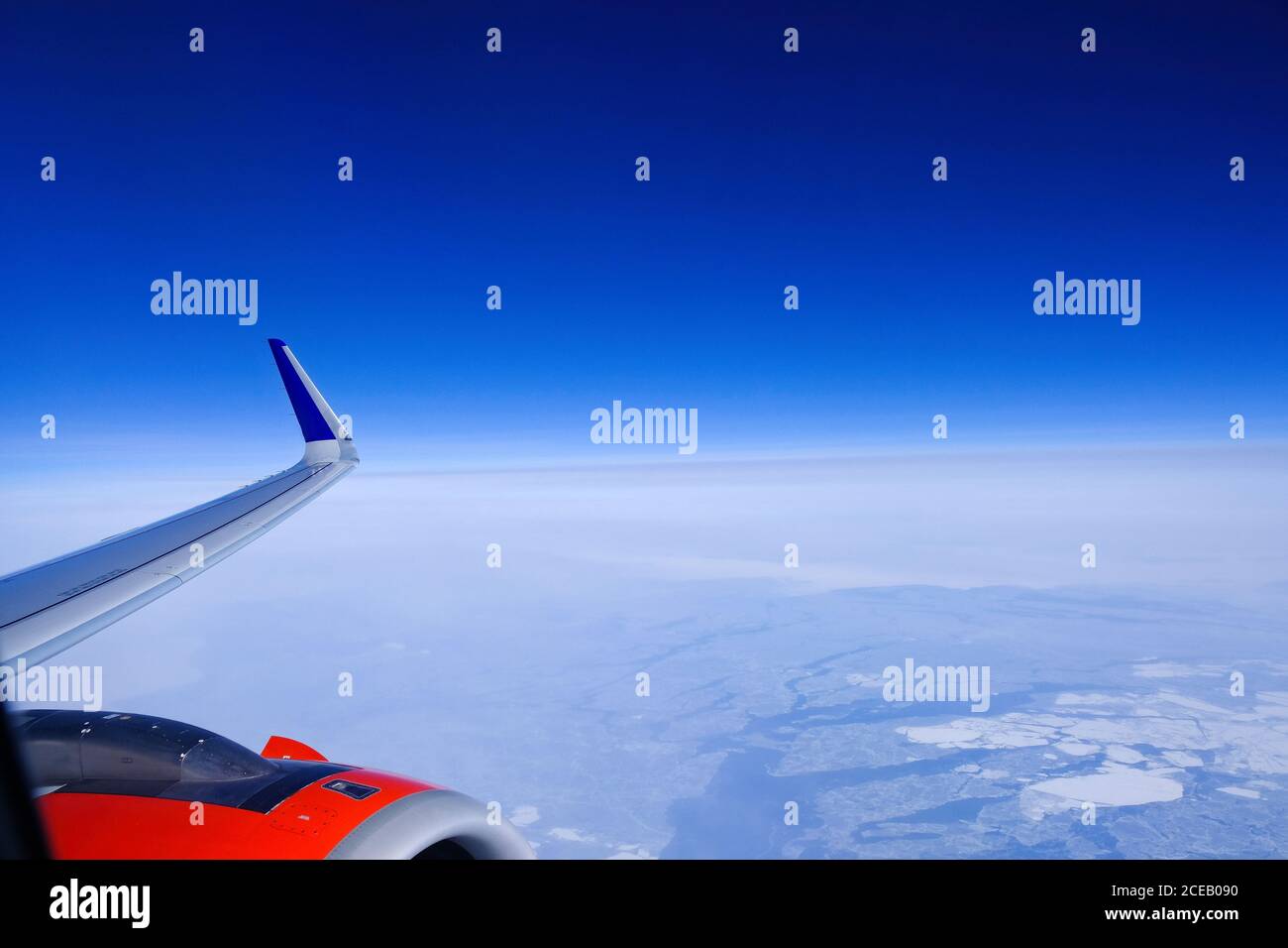 Breathtaking view of sky and plane wing with turbine through window ...