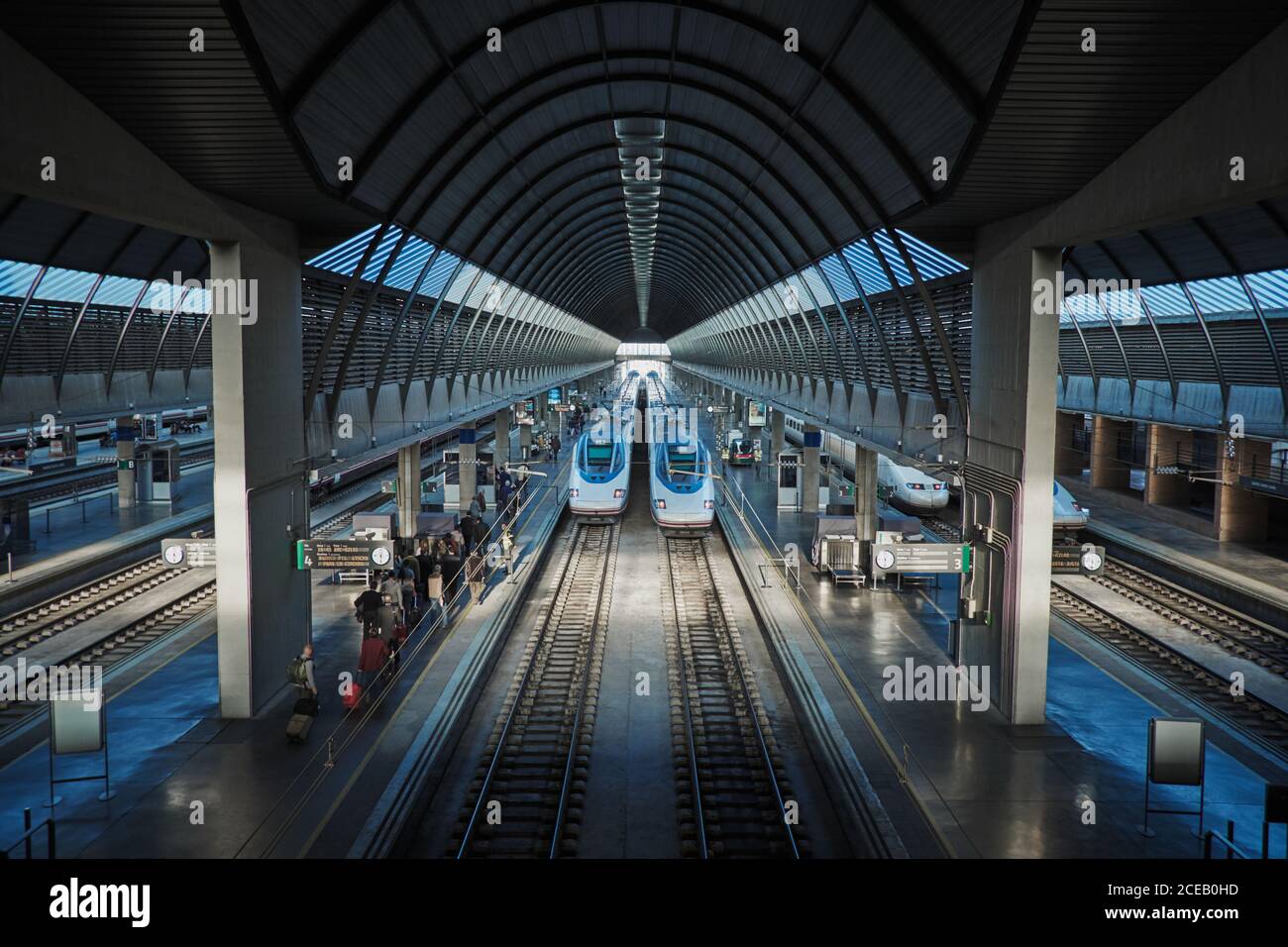 From above view of modern high speed trains moving on railway in spacious roofed railway station Stock Photo