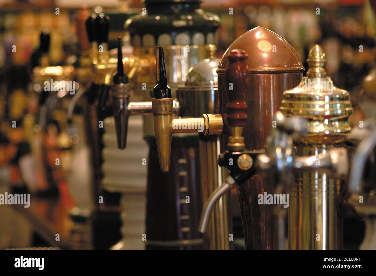 Set of different copper kegs with taps for beer placed in line Stock