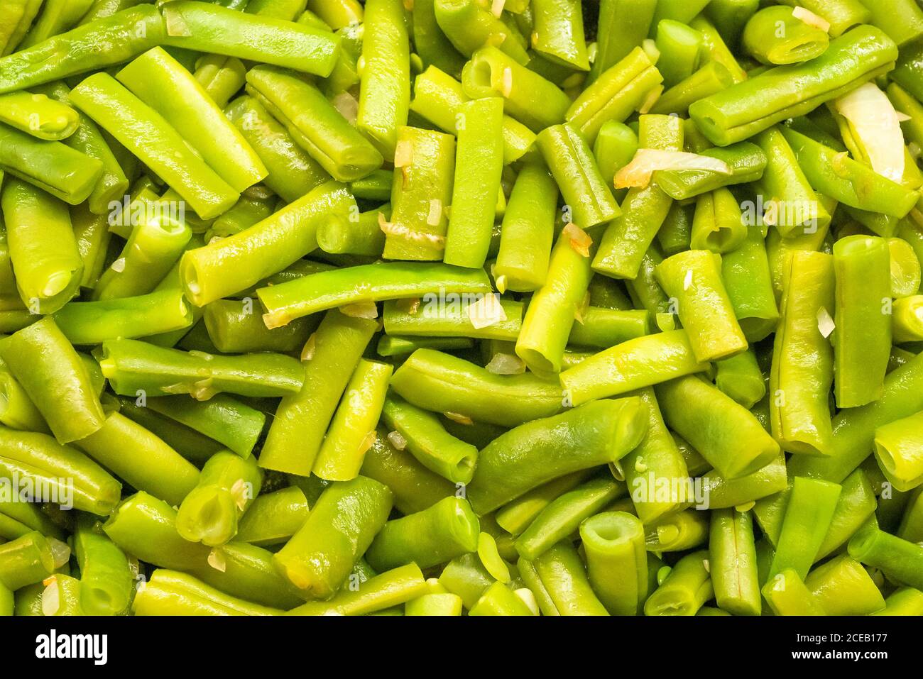 Green beans boiled with onions close up texture. High quality photo