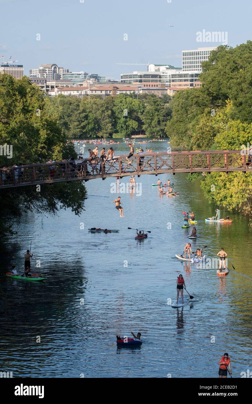 Young people eager to get outdoors during the coronavirus pandemic ignore social distancing guidelines to have fun in the cool waters of Barton Creek south of downtown Austin. ©Bob Daemmrich Stock Photo
