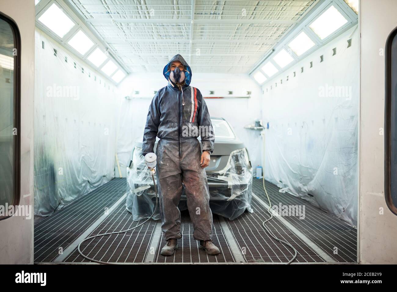painter posing in front of the booth before painting a car Stock Photo Alamy