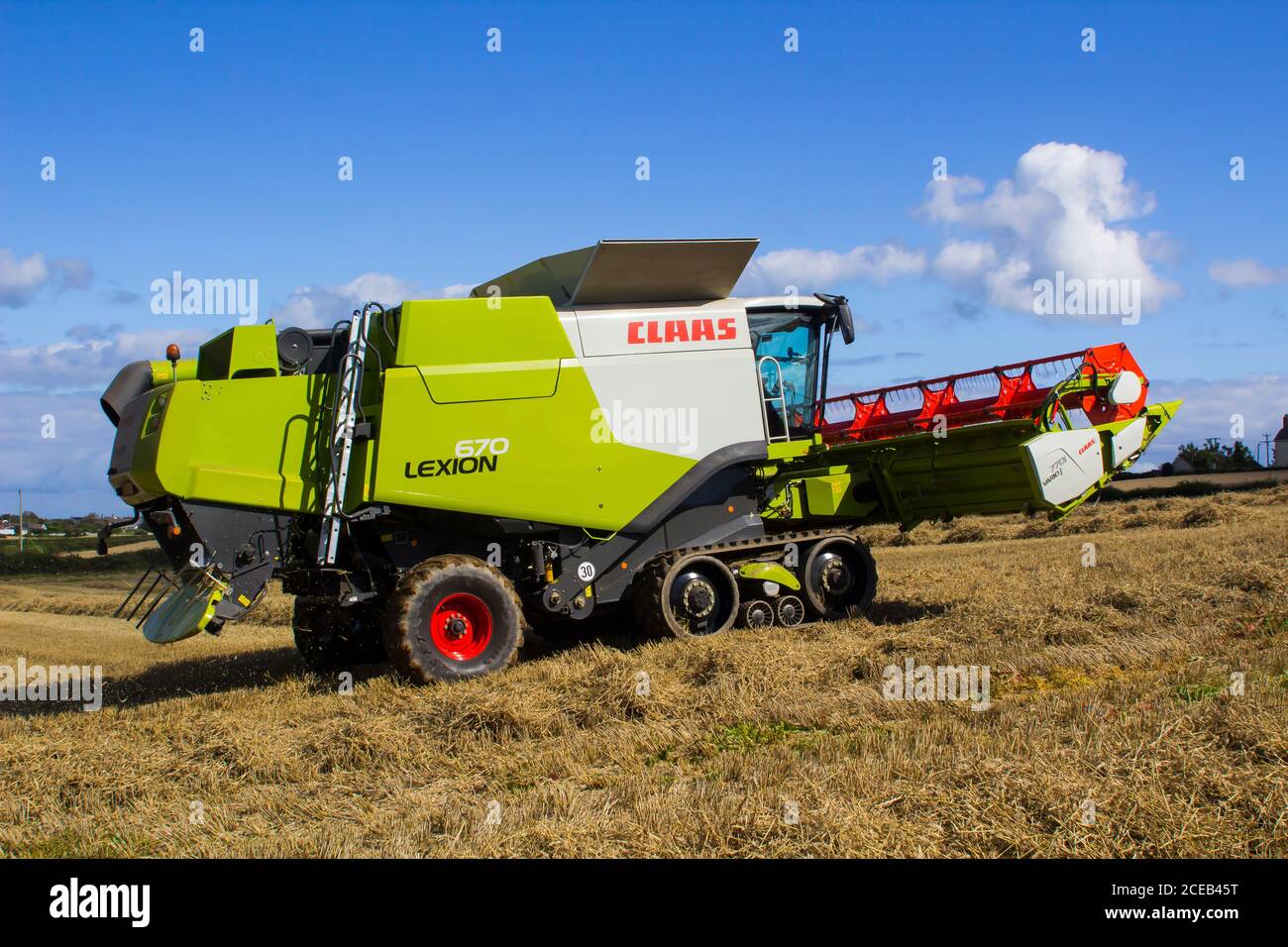 31 August 2020 A Cllas Lexion 570 Combine Harvester at work in a small field of barley corn in Bangor County Down Northern Ireland Stock Photo