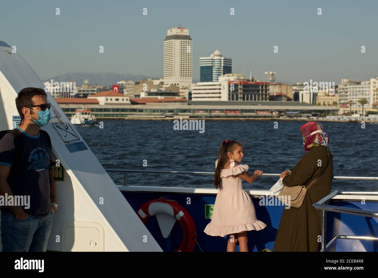 Passengers on a ferry boat passing pasaport, Izmir, Turkey Stock Photo