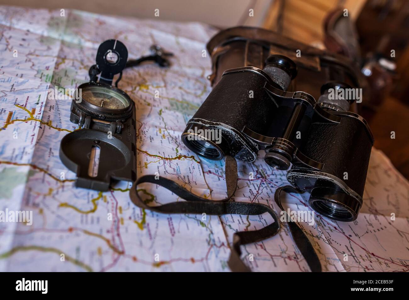planning a trip on a map with prismatic and compass Stock Photo