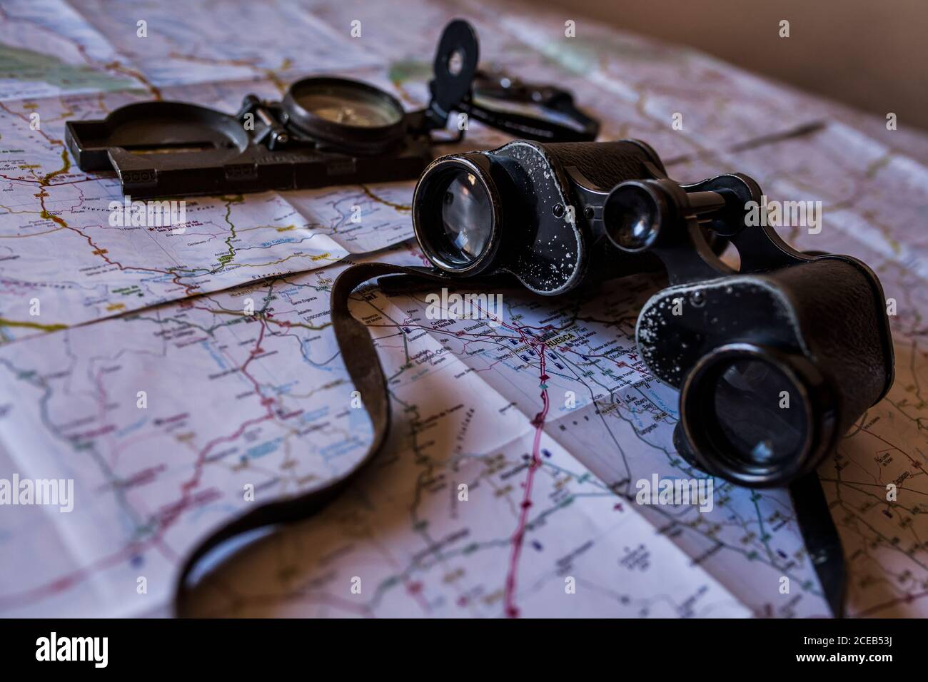 planning a trip on a map with prismatic and compass Stock Photo