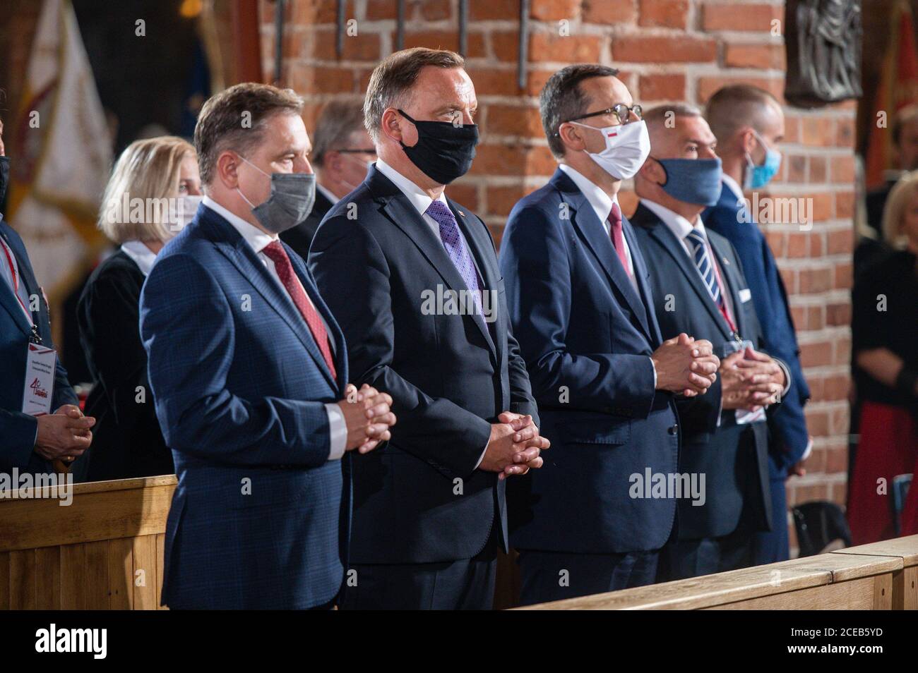 Polish President Andrzej Duda (C) and Prime Minister Mateusz Morawiecki are  seen during a symbolic mass at the Saint Brigid church in Gdansk.The August  Agreements were a symbolic beginning of the Solidarity