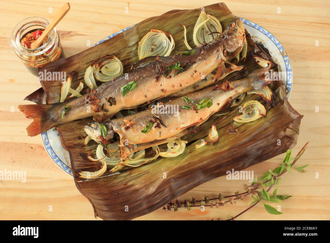 Arctic char, fish, oven baked, thai basil, onions, banana leaf, thai style dipping sauce, Stock Photo