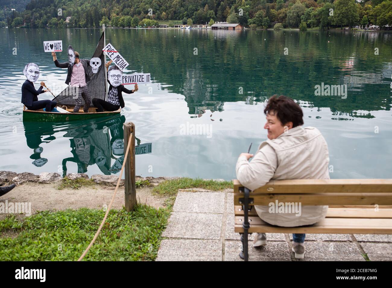 A group of protesters wearing paper masks showing the faces of Slovenian Prime Minister, Janez Jansa, Hungarian Prime Minister, Viktor Orban and Serbian president, Aleksandar Vucic row a small sailboat on Lake Bled protesting against their politics and the rise of fascism in Europe.The protest was held alongside the 15th Bled Strategic Forum where Slovenian Prime Minister Janez Jansa hosted the Hungarian Prime Minister Viktor Orban and Serbian president Aleksandar Vucic, as well as prime ministers of Czech Republic, Bulgaria, Poland, Croatia and others. Stock Photo