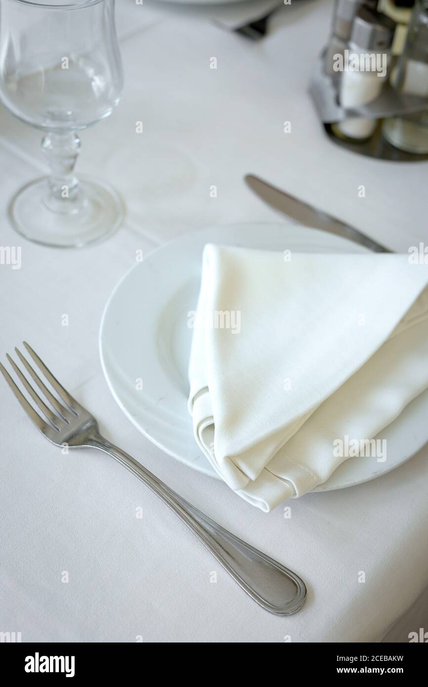 Restaurant table ready to eat. Cutlery, napkins, cups; dishes Stock