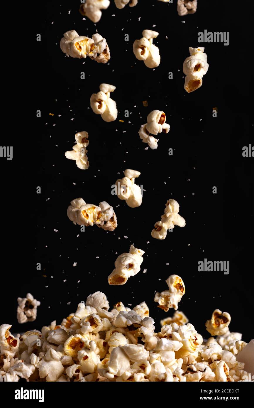 Popcorn falling down in black background Stock Photo Alamy