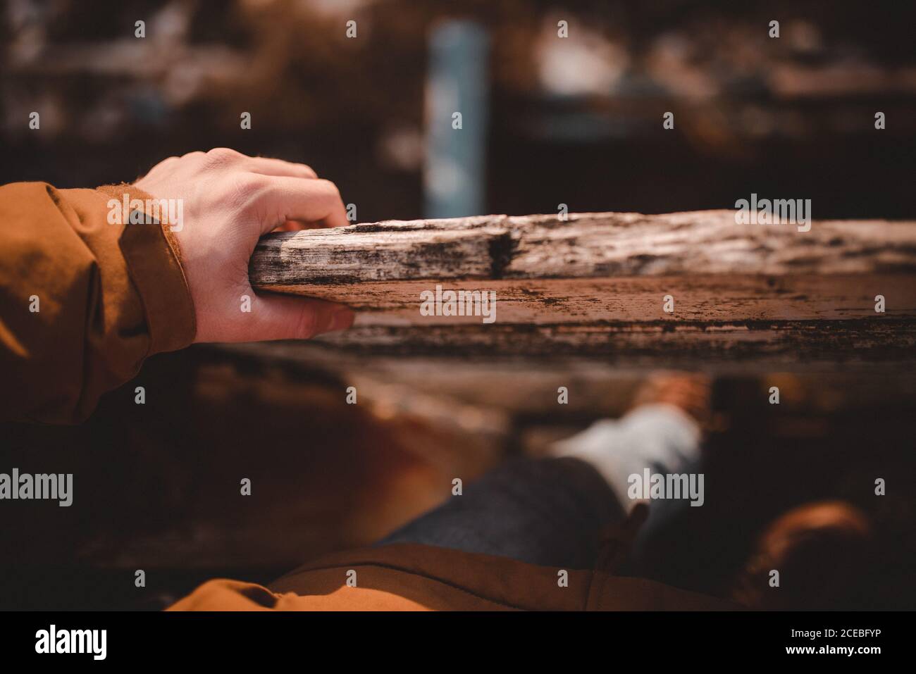 From above shot of anonymous tourist keeping hand of aged timber railing Stock Photo