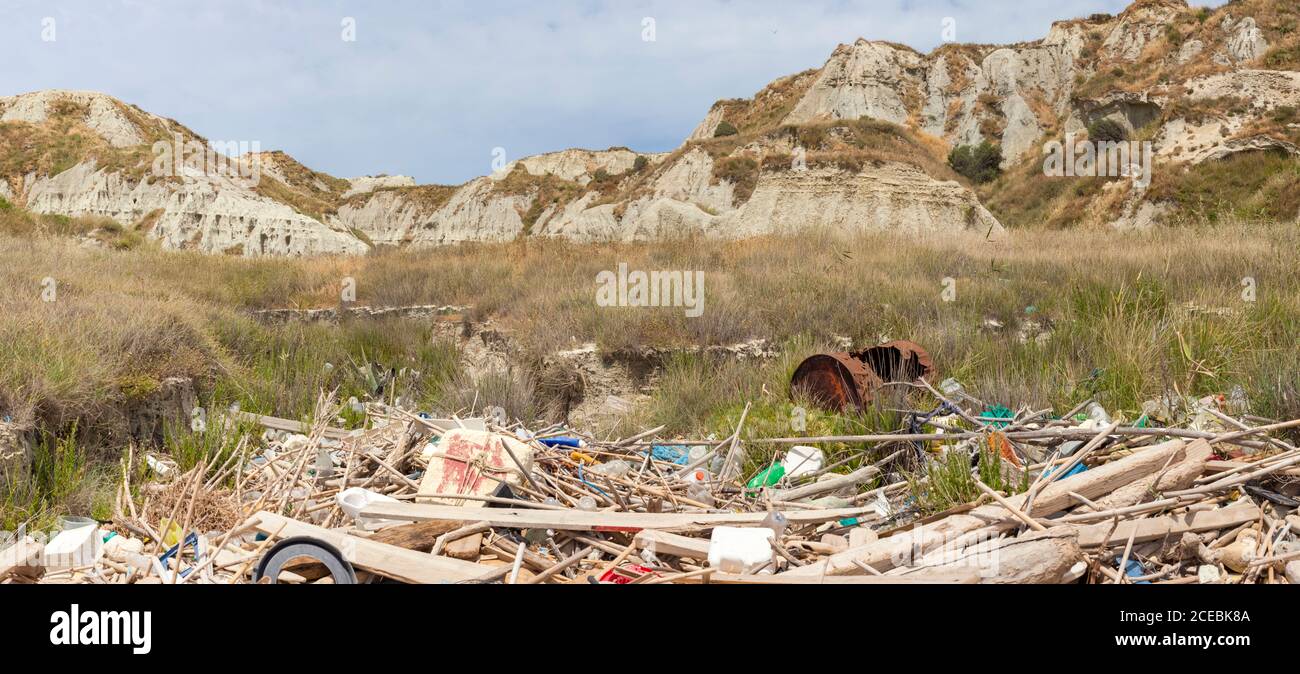 Heap of garbage lying on ground near stony hills on Cefalonia Island, Greece Stock Photo
