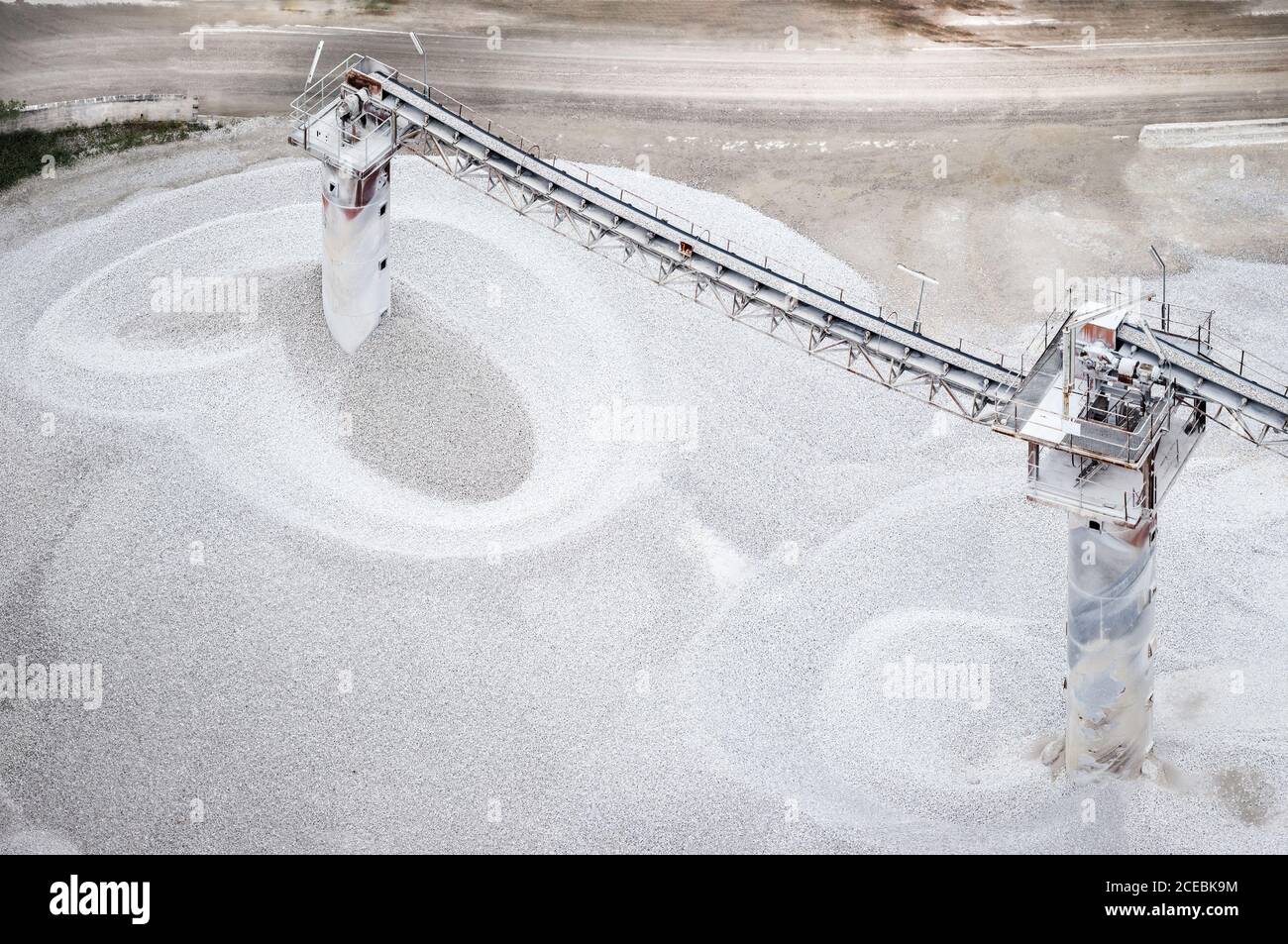 Drone view of two towers with conveyor belts transporting cement on factory in Asturias, Spain Stock Photo