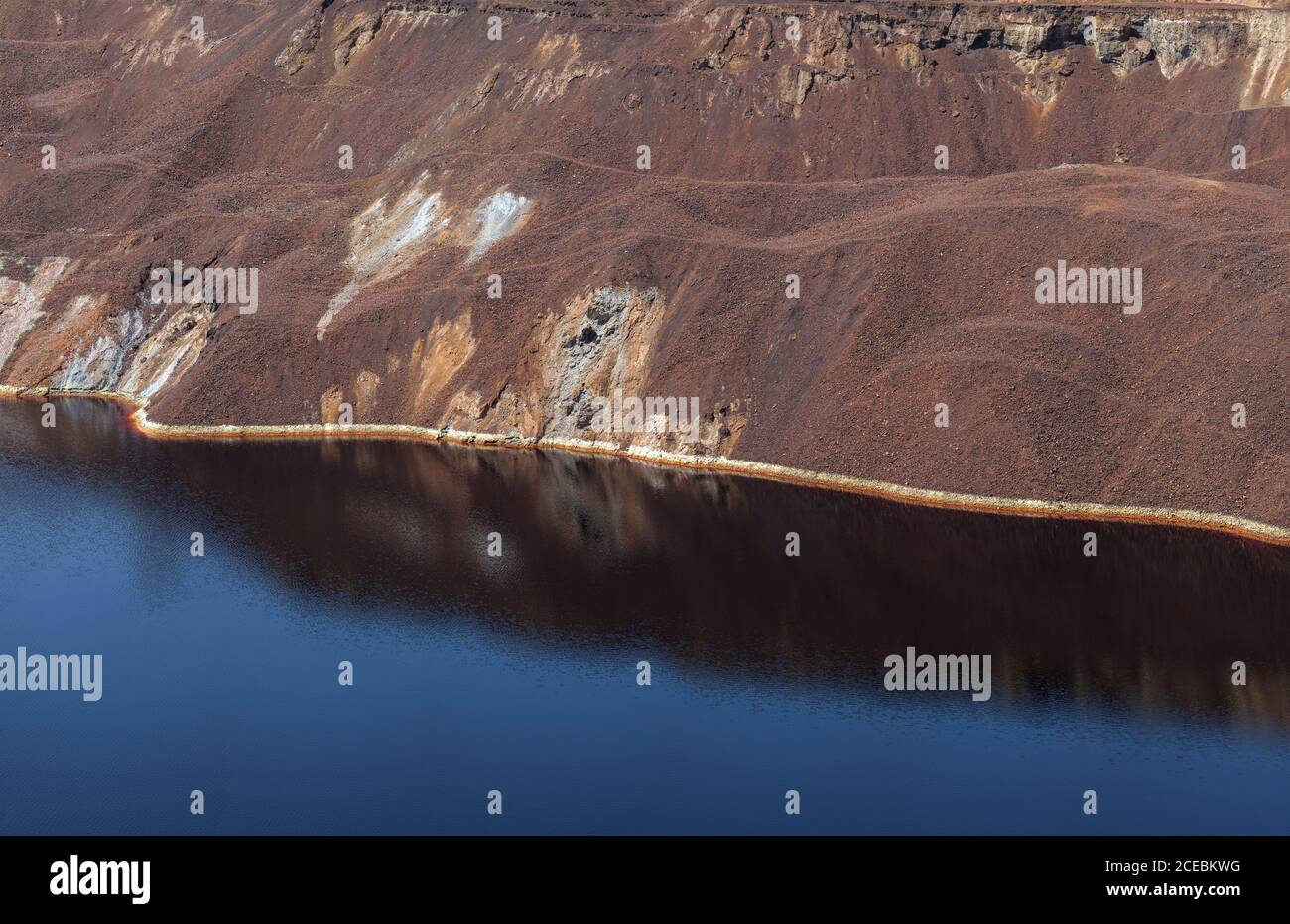 Calm surface of water near slope of quarry in Santo Domingos Mine, Portugal Stock Photo