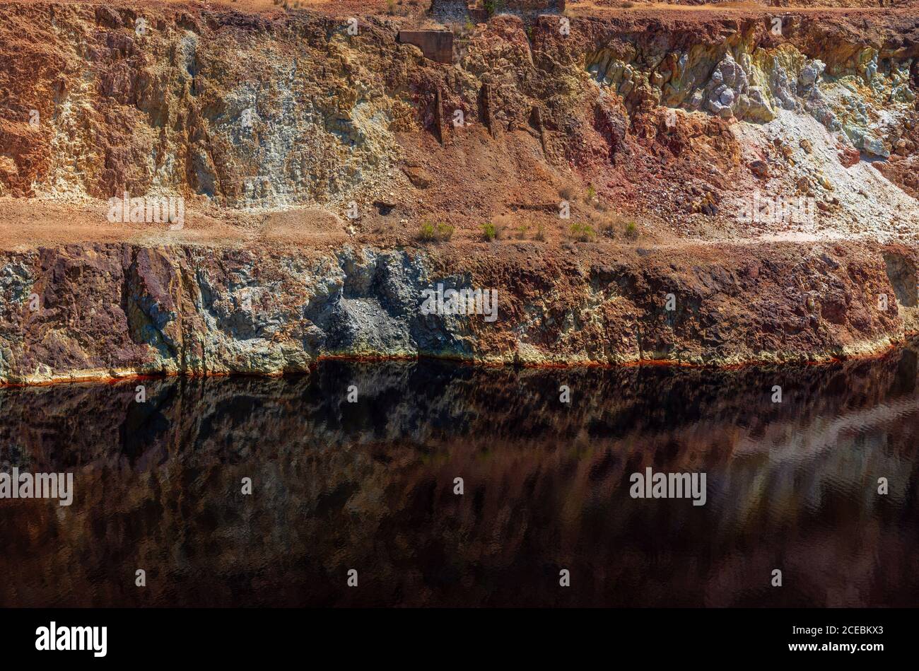Calm surface of water near slope of quarry in Santo Domingos Mine, Portugal Stock Photo