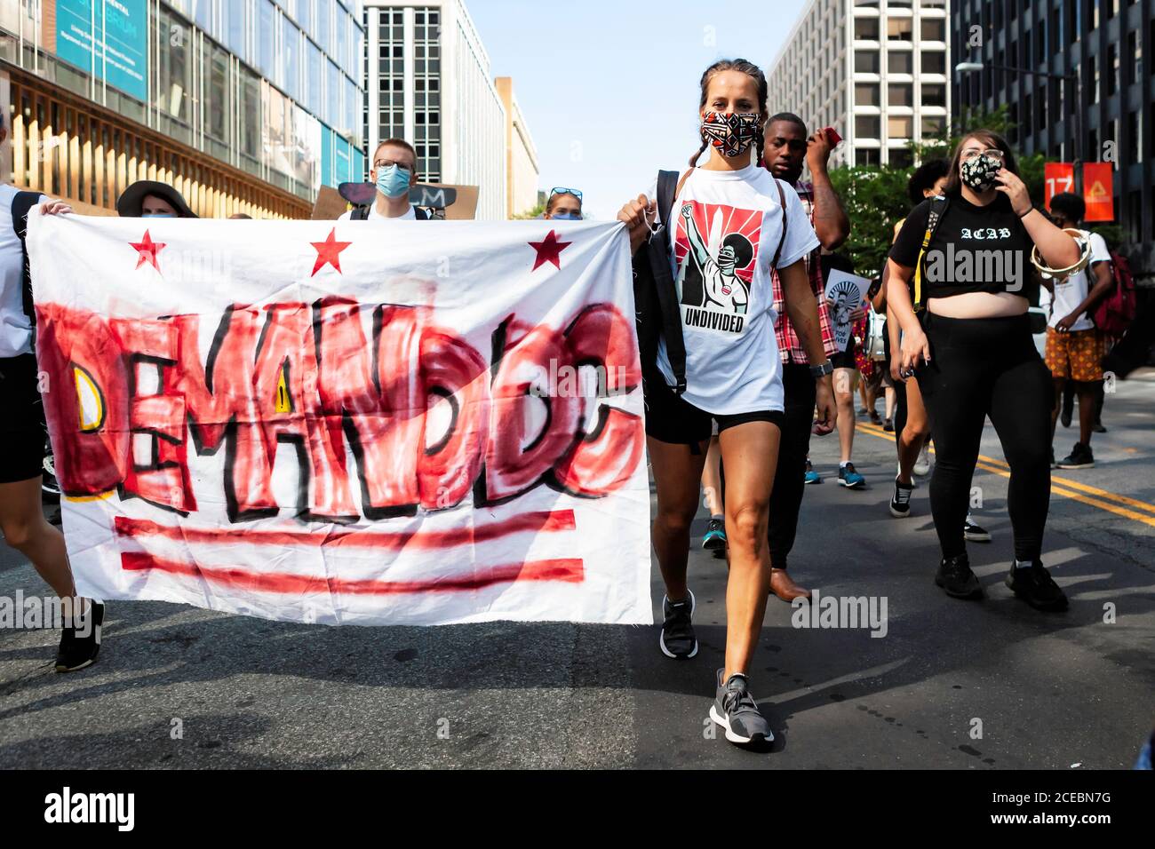 Washington, DC, USA, 28 August, 2020. Pictured: Protesters from The Palm Collective carry their Demand DC banner at the head of a protest march. Loca Stock Photo